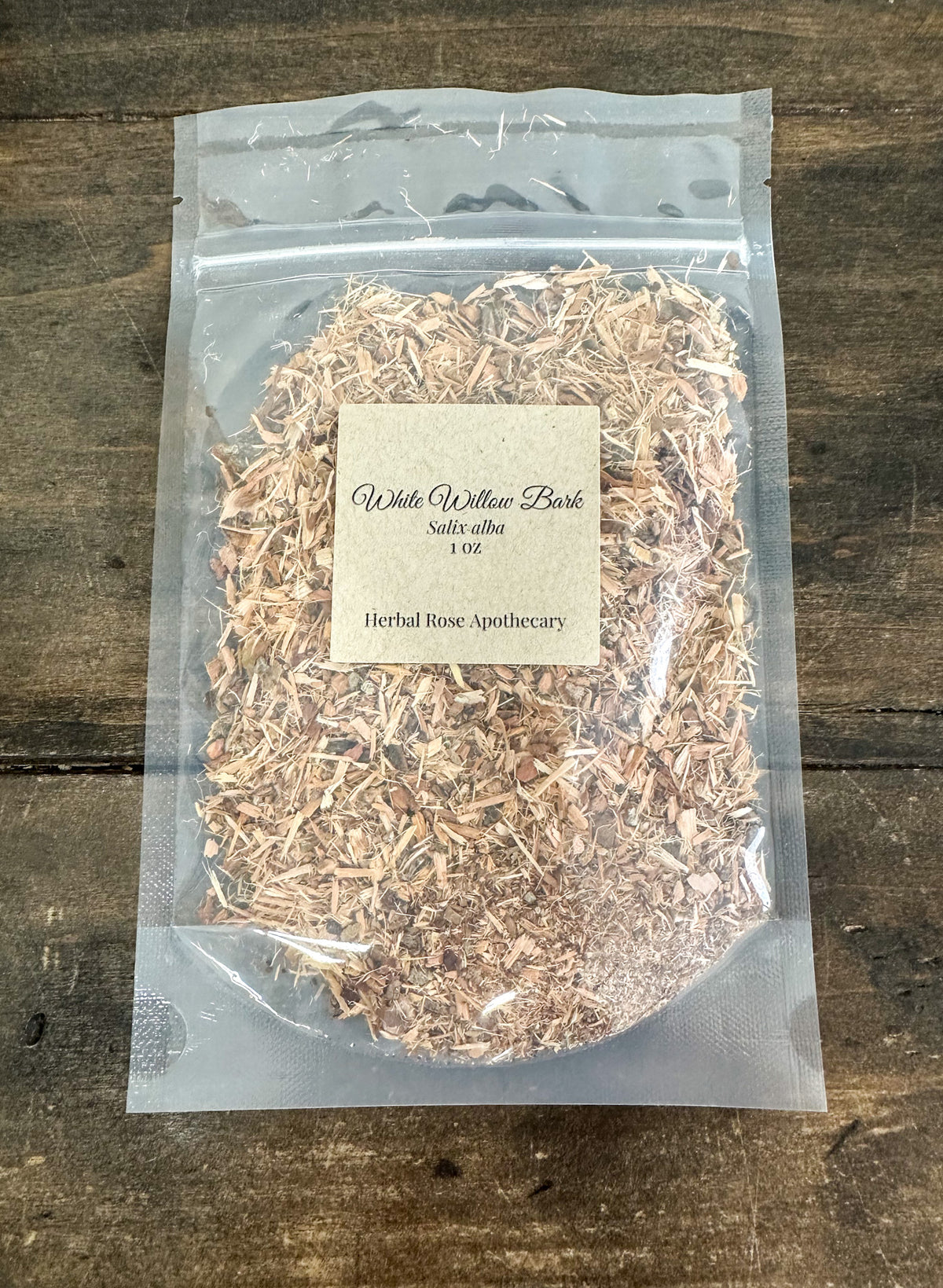 dried white willow bark in 1oz clear resealable bag on wooden surface
