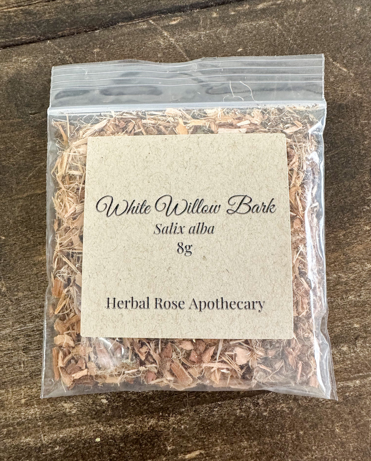 dried white willow bark in 8g clear resealable bag on a wooden surface