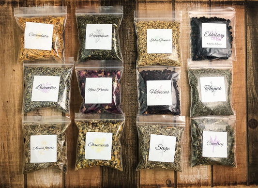 herbal sample pack of 12 clear 8g bags filled with dried herbs on a wooden table as a background