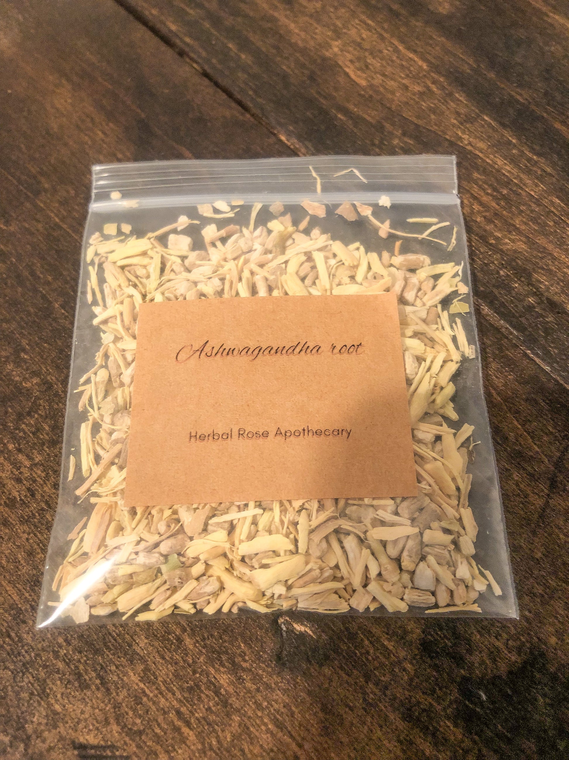 ashwagandha root 8g in clear bag on wooden background