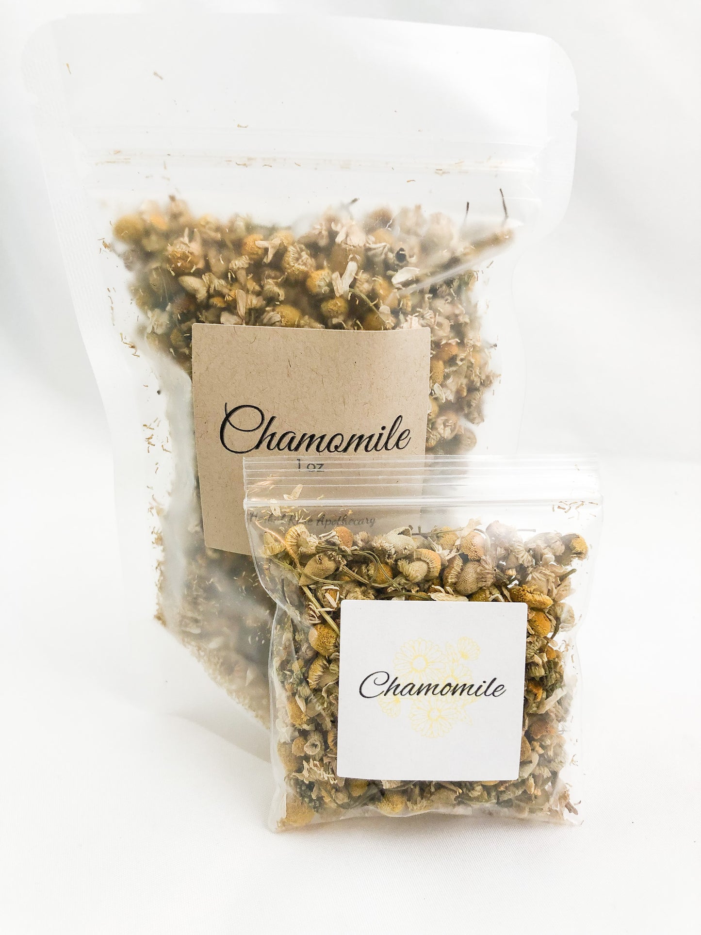 dried chamomile in clear 8g bag and clear 1oz bag with white background