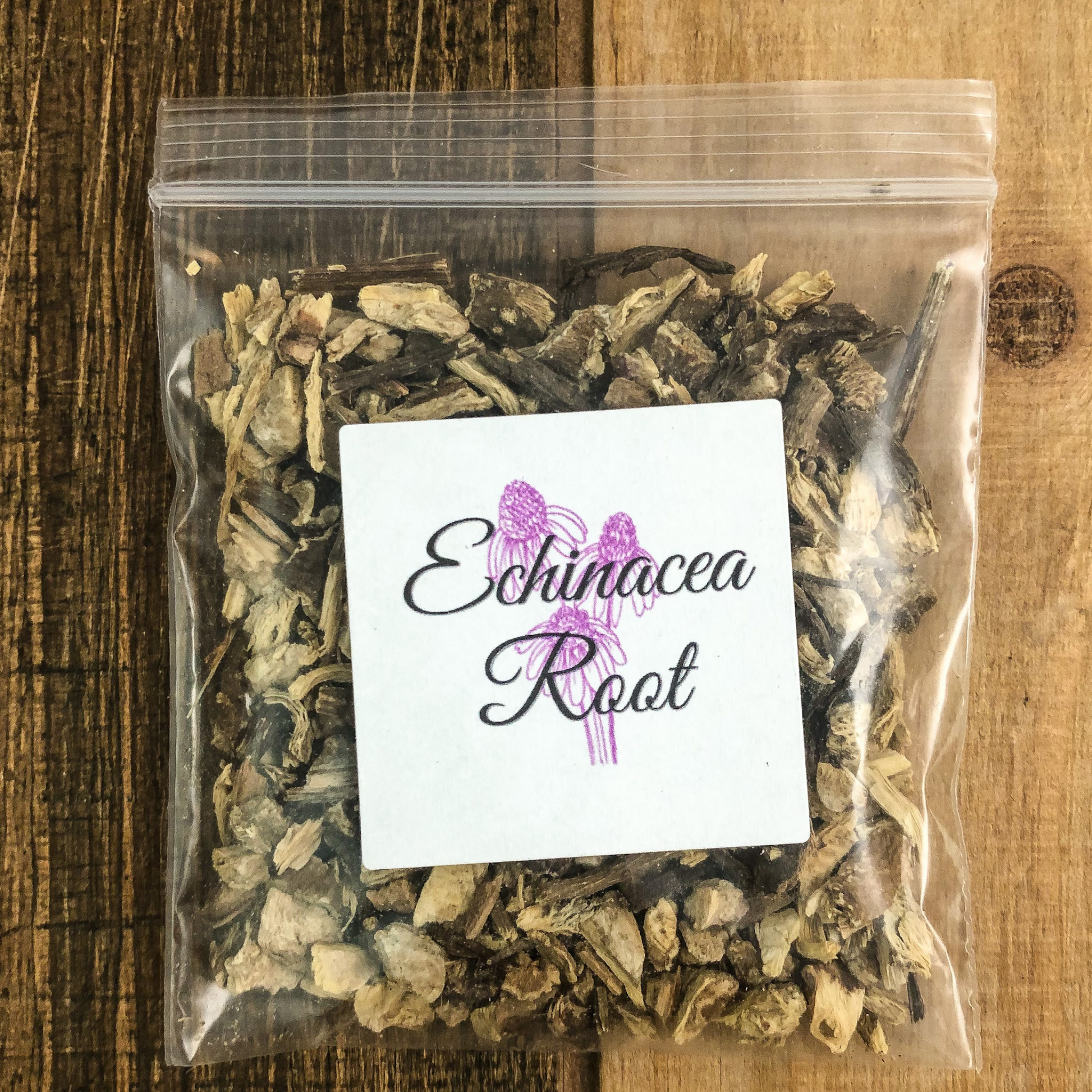 dried echinacea in a clear 8g bag with wooden table as background