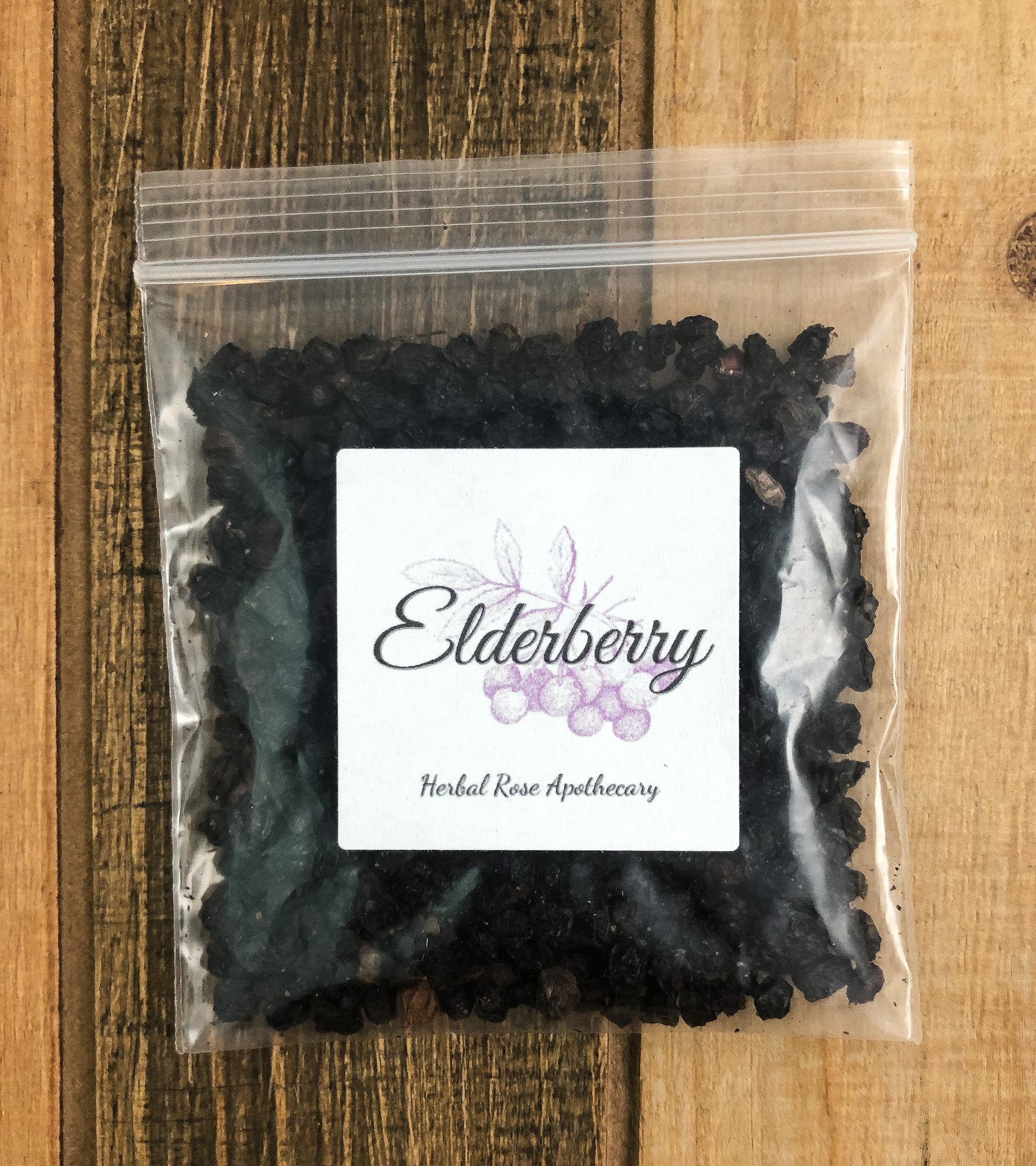8g bag of dried elderberry in a clear plastic bag with a wooden background