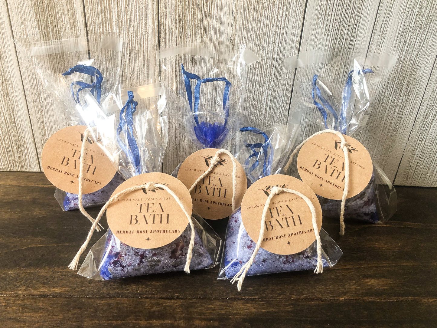 bulk herbal tea bath party favor/appreciation gifts on wooden table with white wooden background