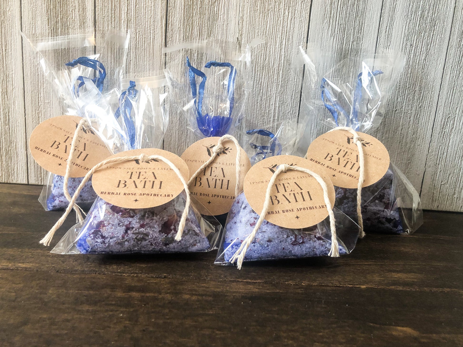 bulk herbal tea bath party favor/appreciation gifts on wooden table with white wooden background