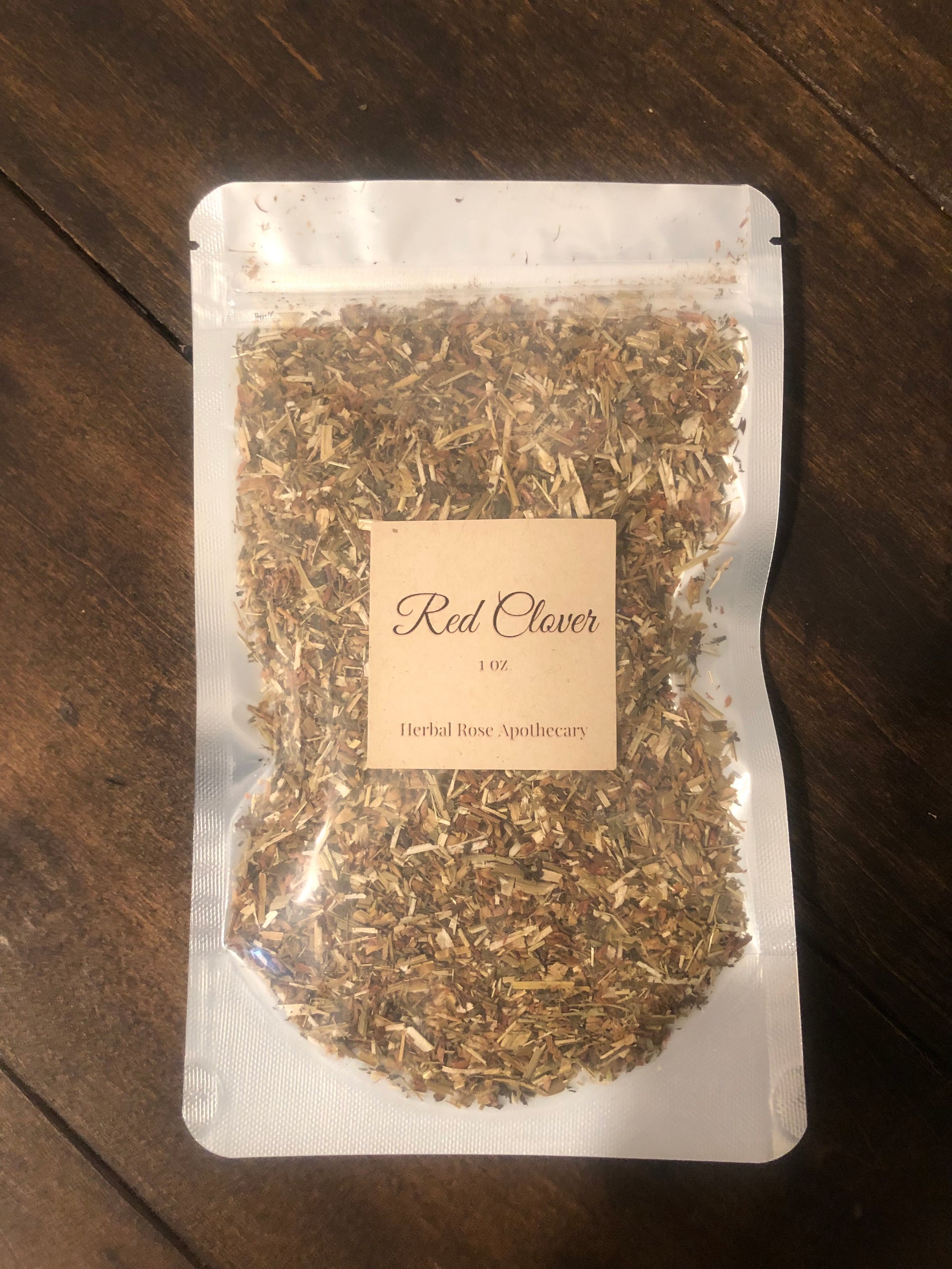 red clover 1oz in clear bag on wooden background
