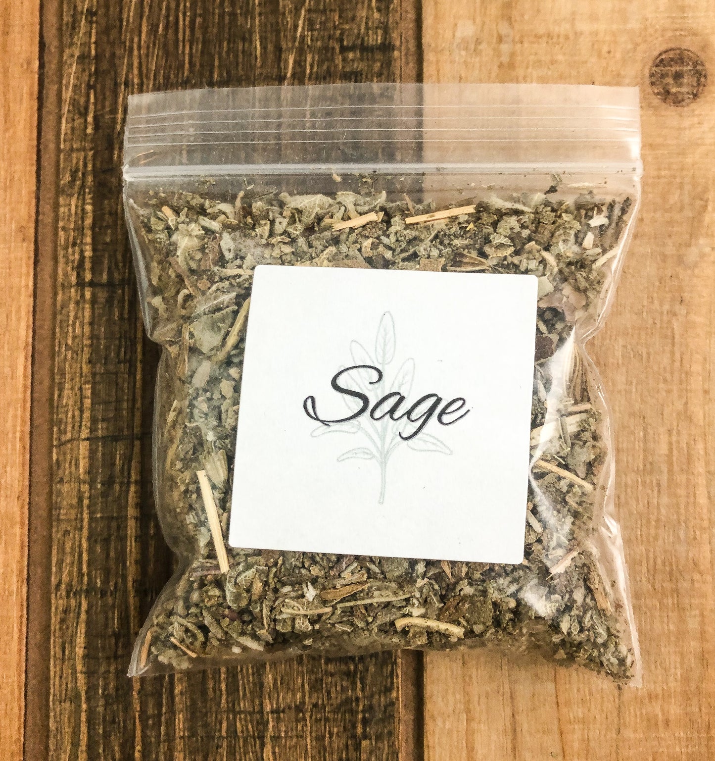 8g bag of dried sage in a clear plastic bag with a wooden background
