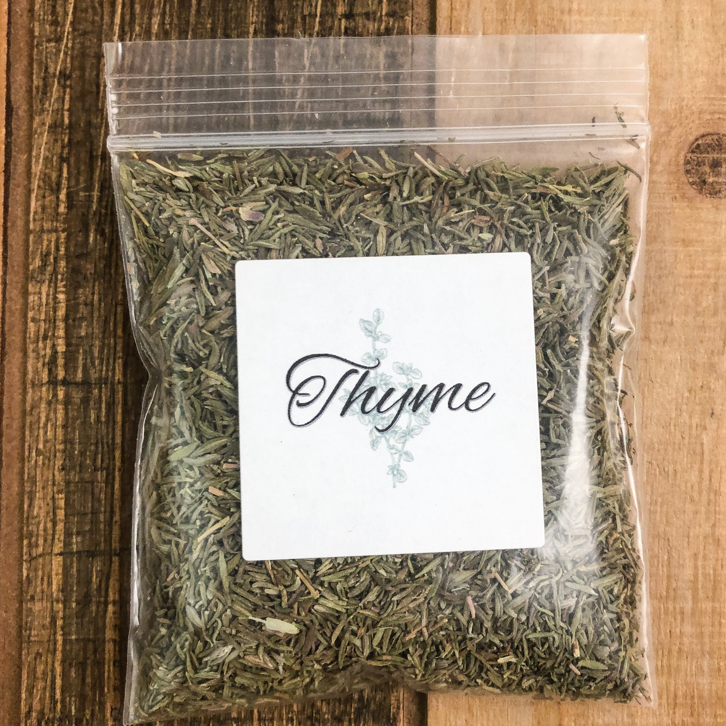 8g bag of dried thyme in a clear plastic bag with a wooden background
